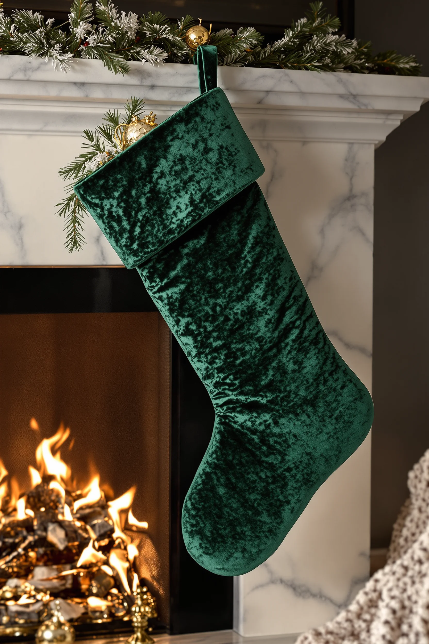 fireplace garland christmas inspiration with luxurious crushed velvet stocking and silver ornament details on elegant white mantel