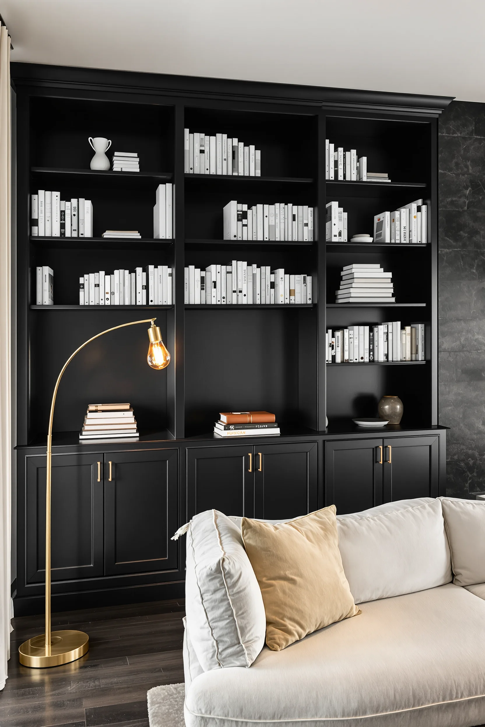 dark apartment designs showing charcoal floors brass accents and cream sofa with dramatic shadows
