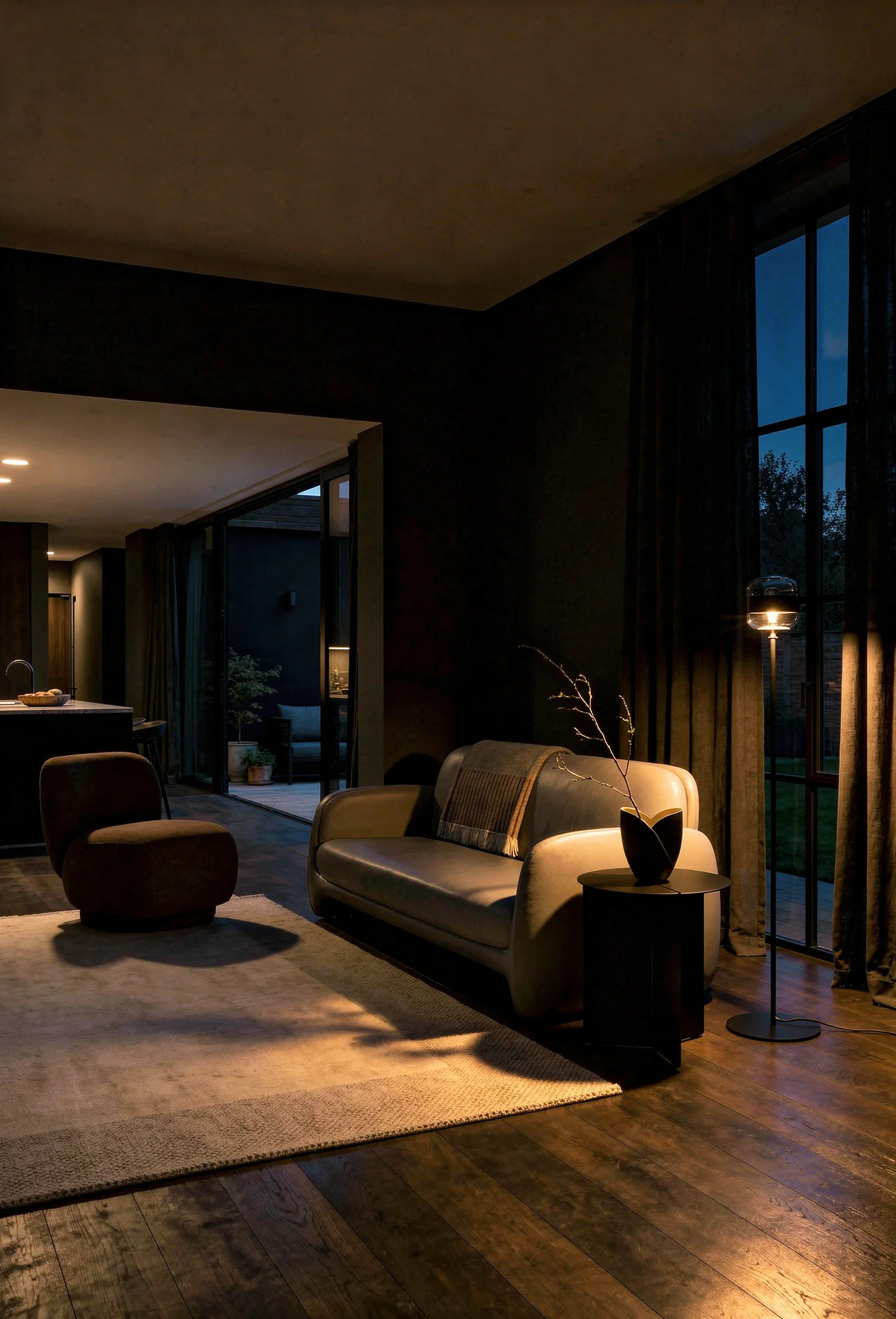 How to design a modern living room featuring gray sculptural sofa with charcoal walls and brown lounge chair evening mood