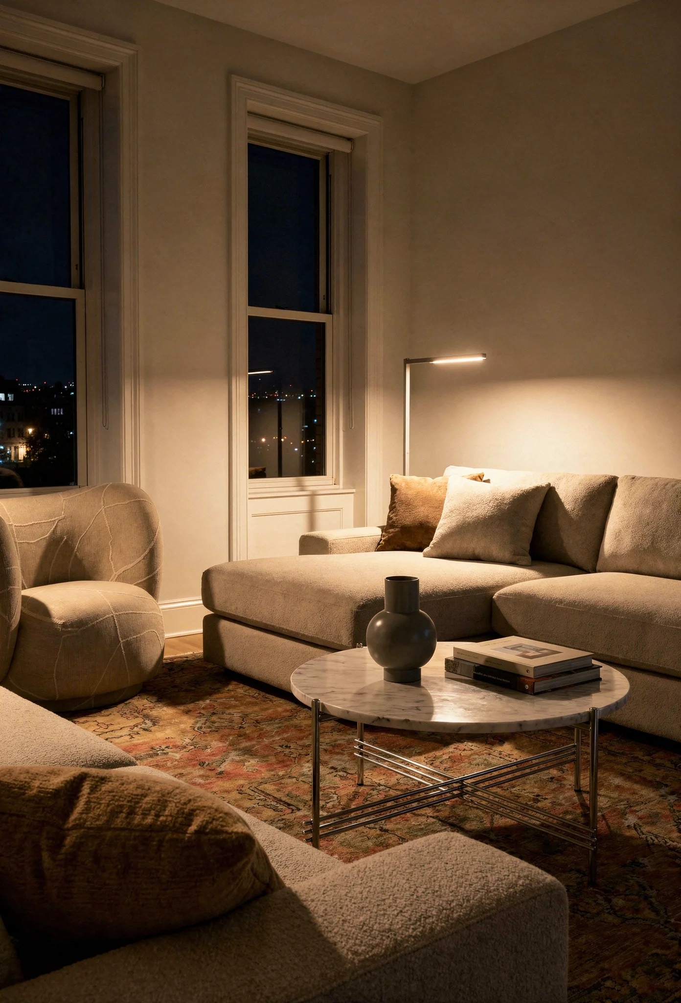 How to design a modern living room featuring ivory chaise sofa with round marble coffee table evening mood