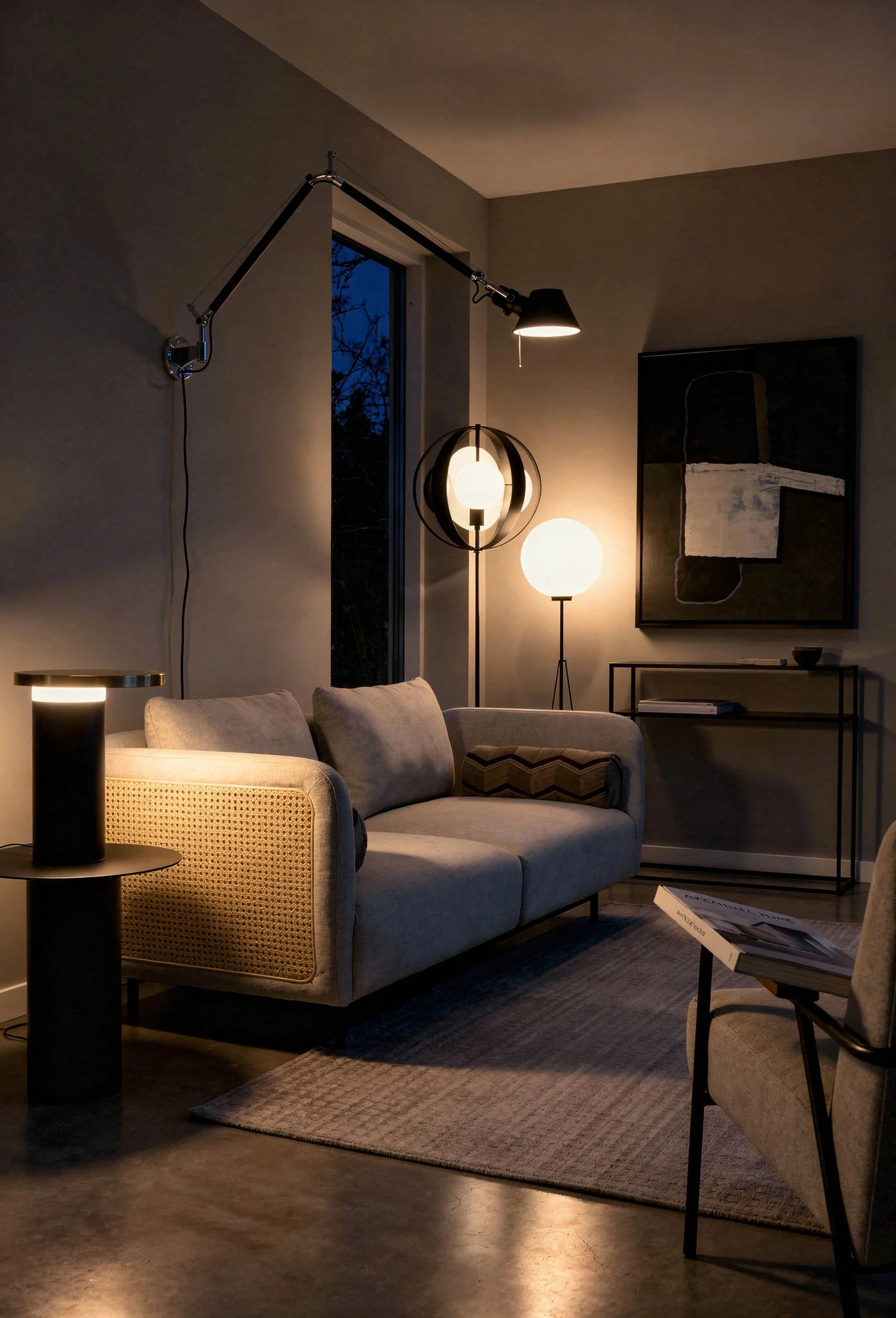 Modern living room lighting featuring sculptural black lamps with light gray cane sofa evening mood