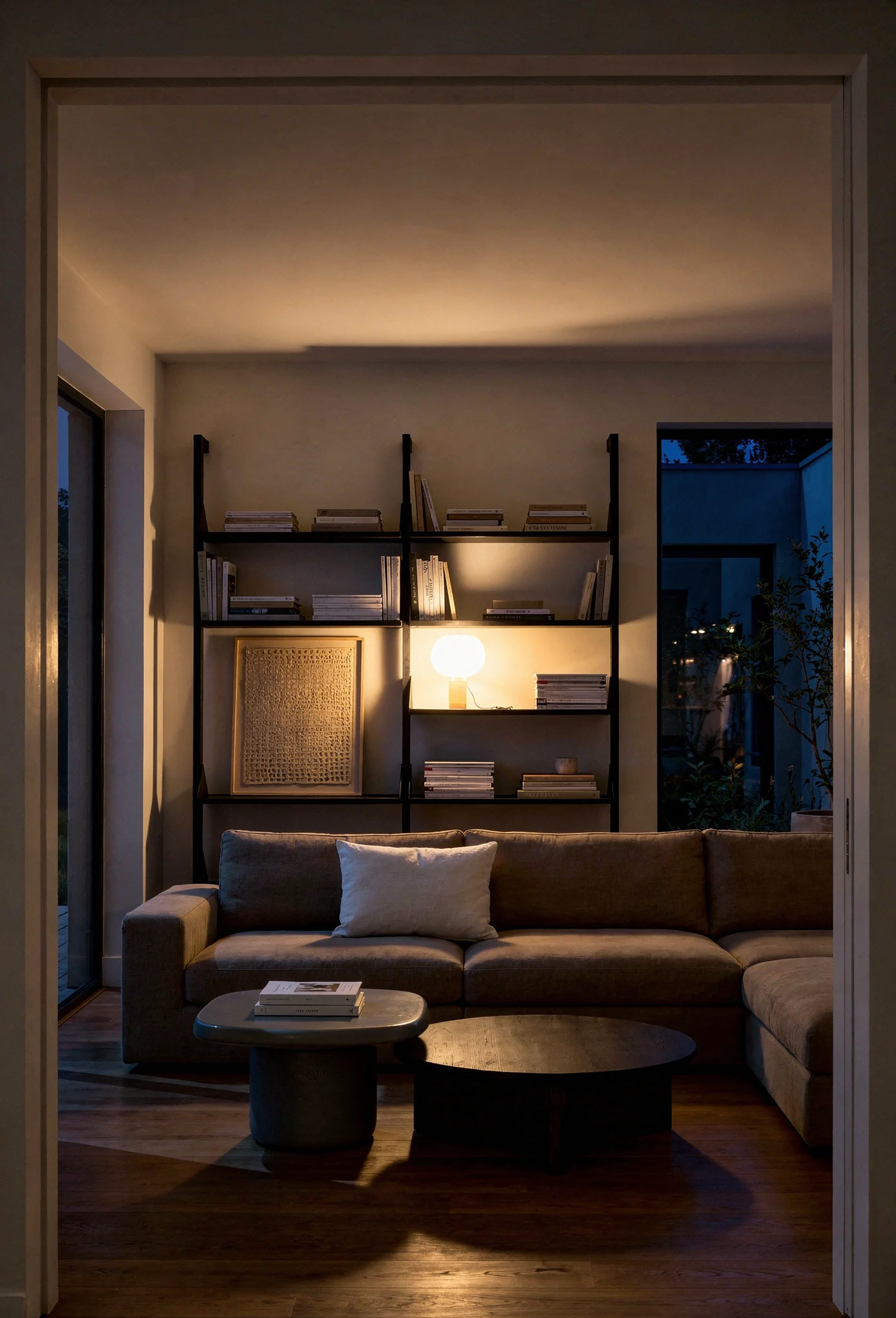 Modern living room tv cabinet design featuring tan linen sectional with black ash shelving unit evening mood