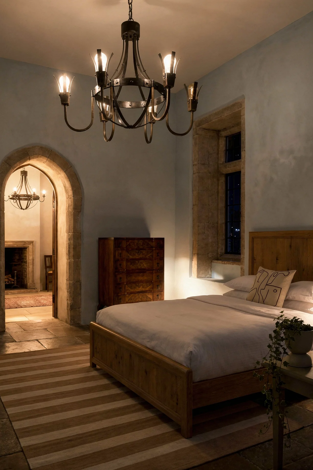 French Country Bedrooms featuring wrought iron chandelier with driftwood bed and pale blue walls evening mood