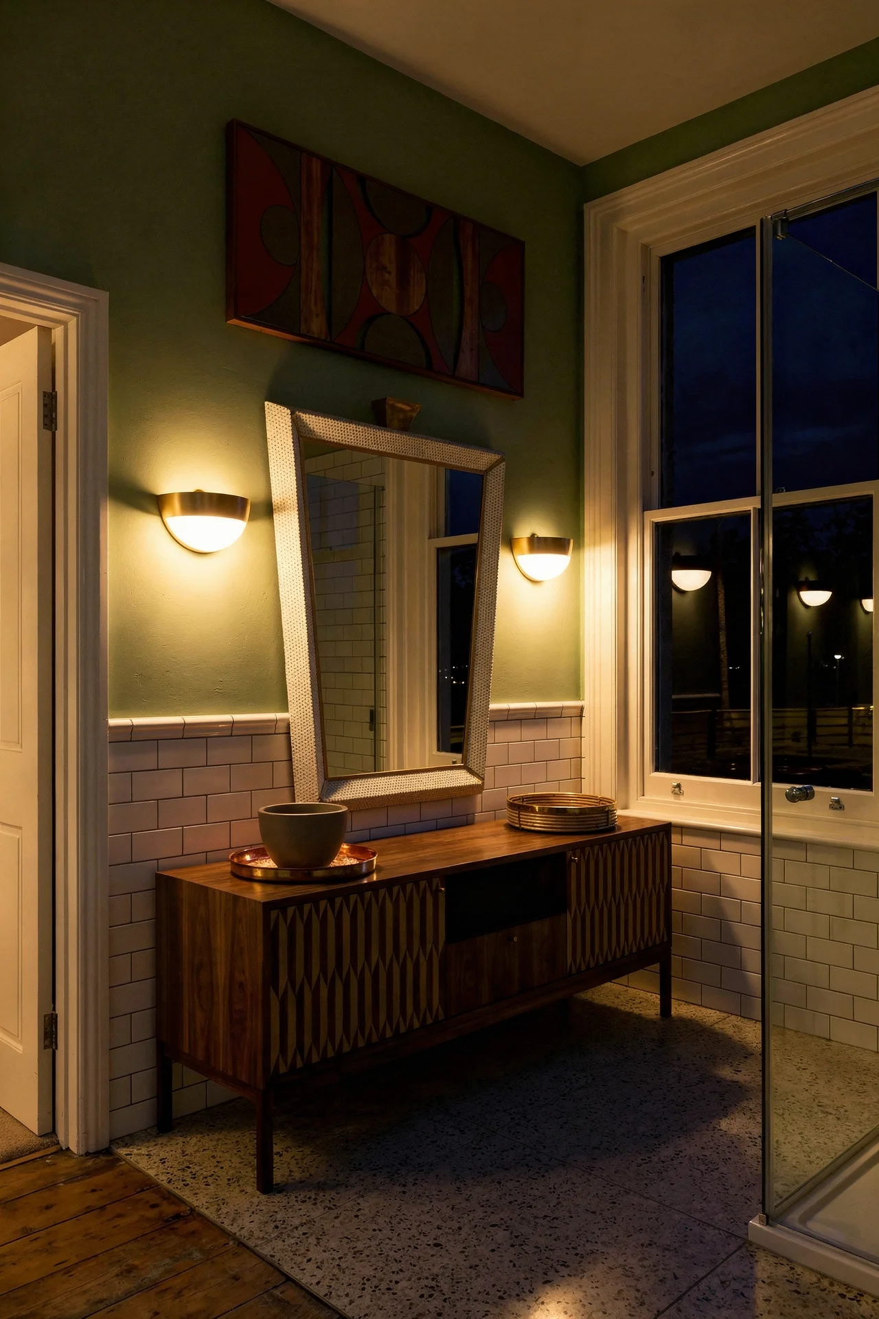 Mid Century Modern Bathroom featuring walnut vanity console with inlaid doors and tapered MCM legs with XXL illuminated brass mid century wall m evening mood