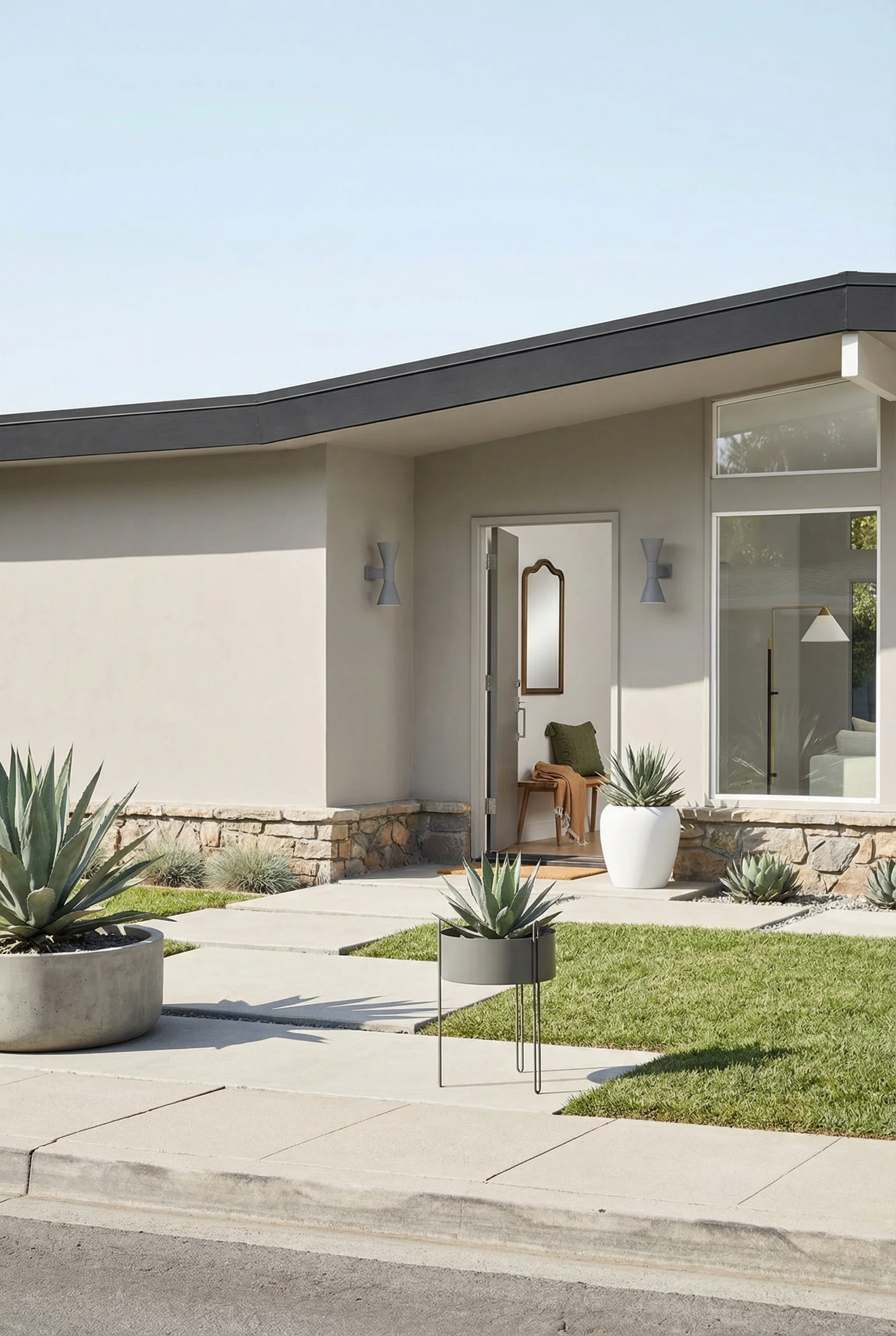 Mid century modern house exterior featuring geometric le corbusier sconce with sculptural blow planter