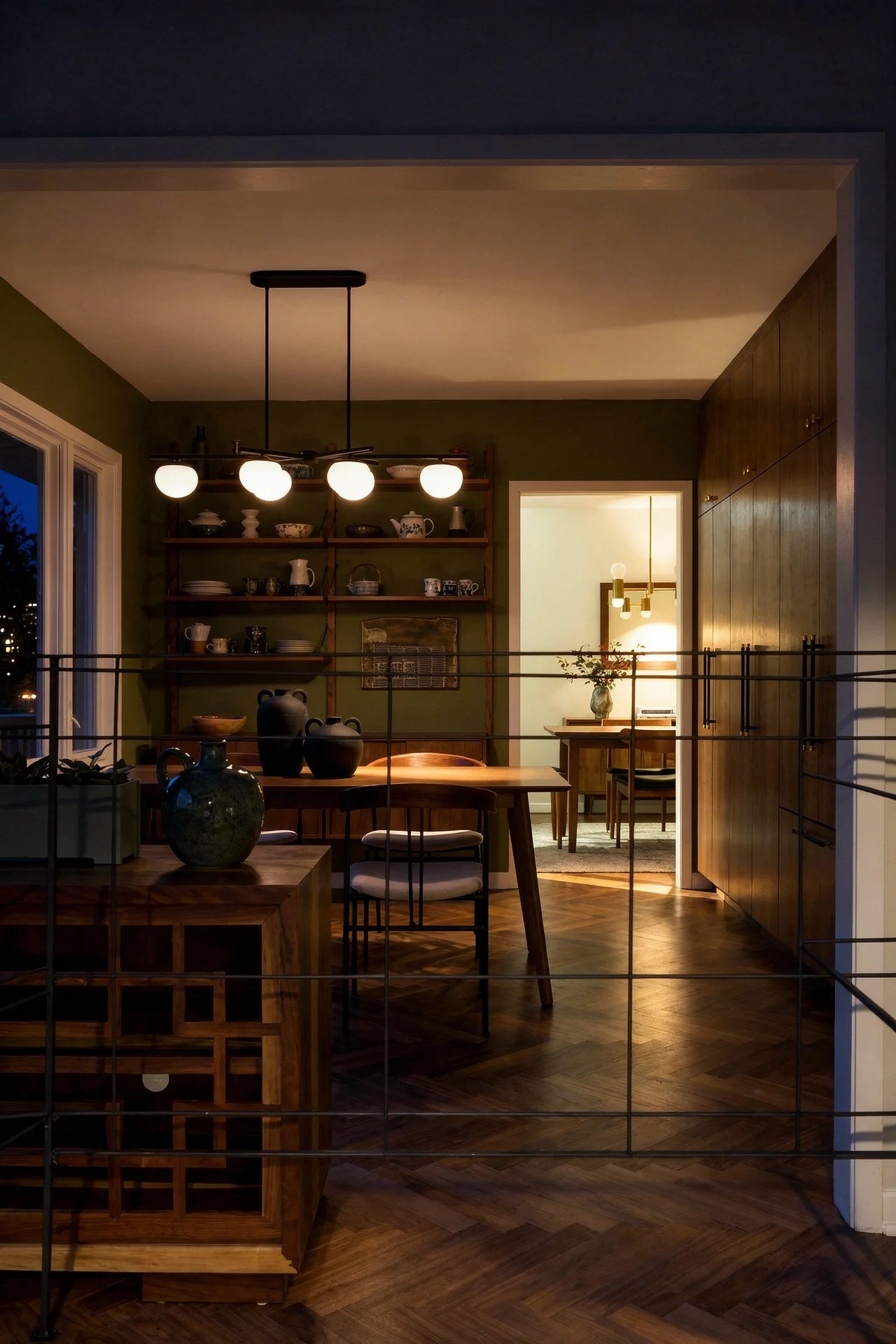 Mid century modern kitchen featuring gubi violin dining chair in walnut with visual comfort lune linear chandelier in black/white evening mood