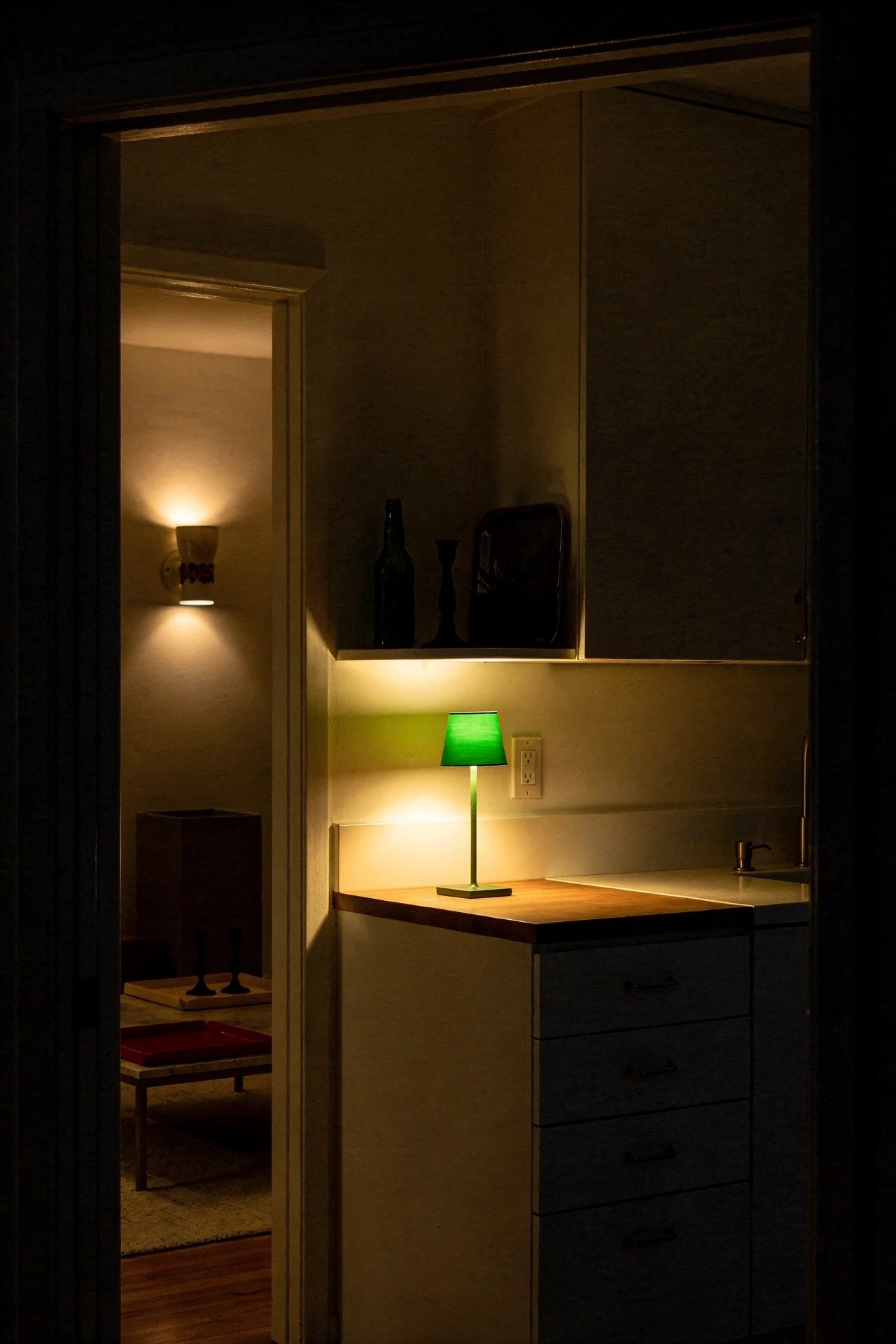 Mid century modern kitchen featuring MCM accent additions transforming white kitchen with green lamp evening mood