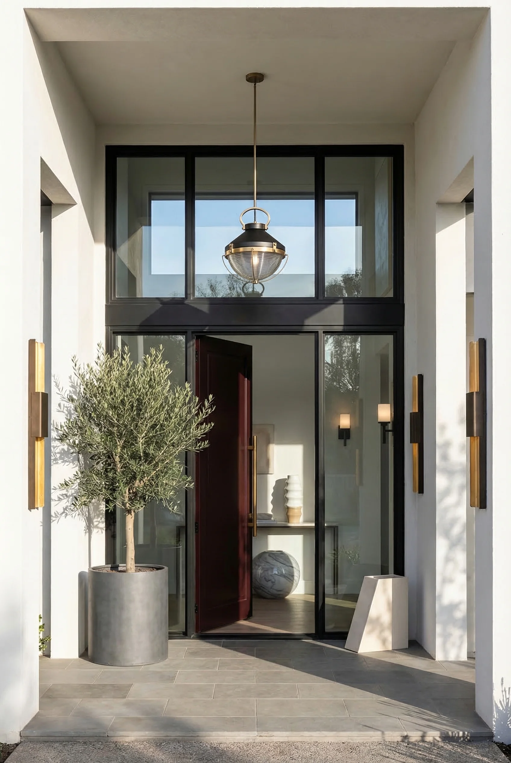 Exterior doors with glass panels modern featuring bronze wall sconce with gray tackett planter at double-height entry