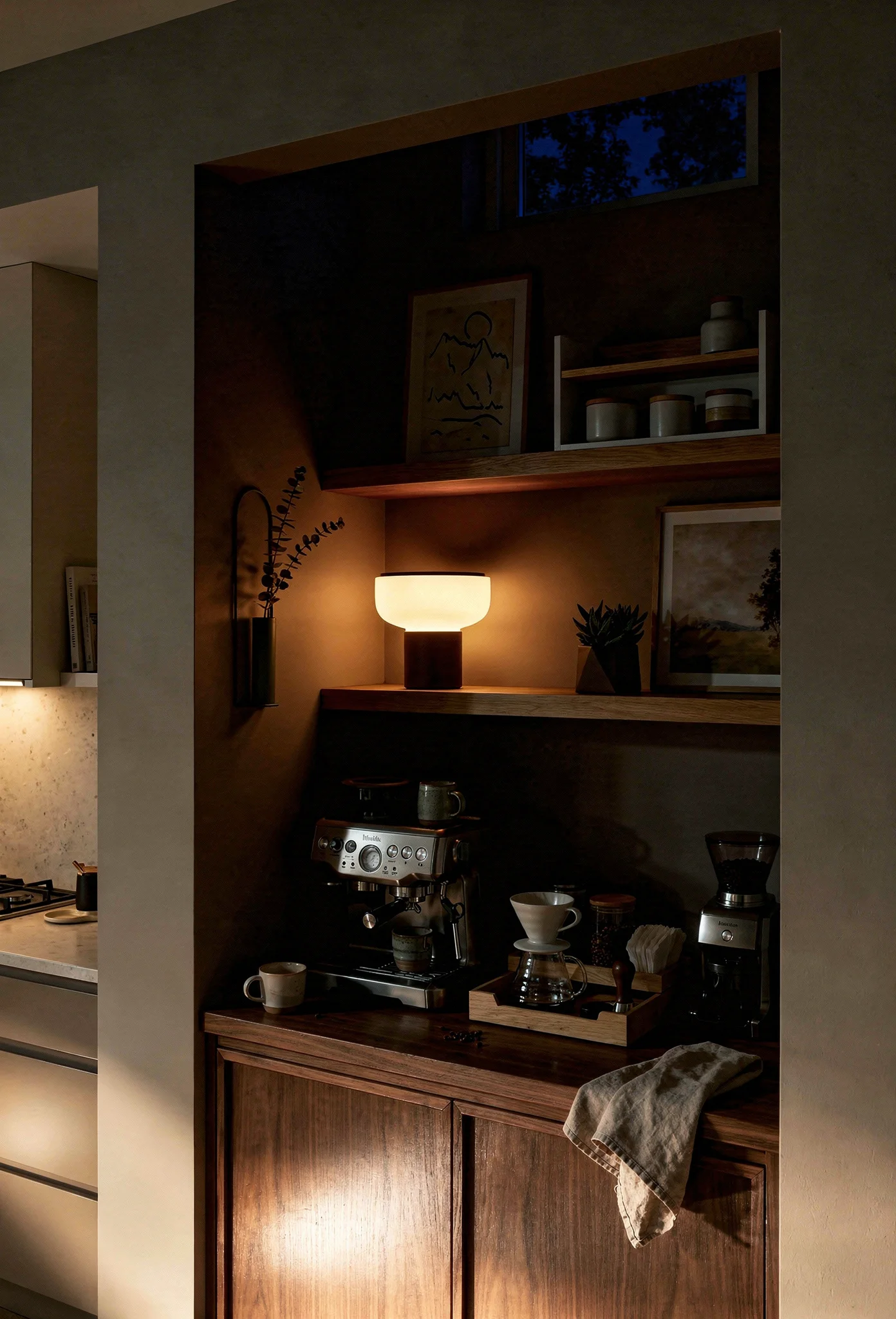 Modern kitchen coffee nook featuring walnut LED table lamp with oak shelving and mountain landscape art evening mood