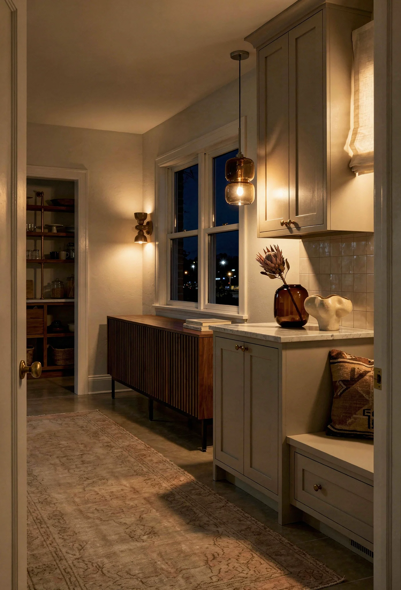 Modern kitchen walnut cabinets featuring smoke glass pendant with brass knobs and zellige backsplash evening mood