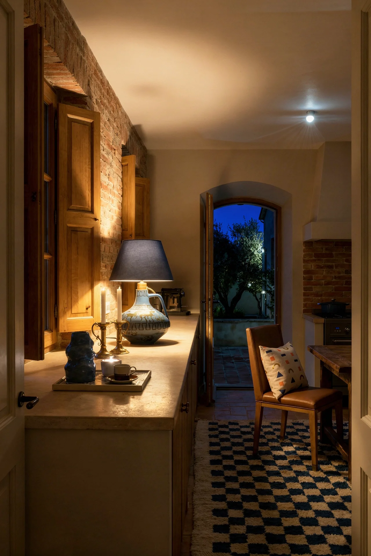 French country kitchen evening lighting featuring brown oak chairs with terracotta backsplash