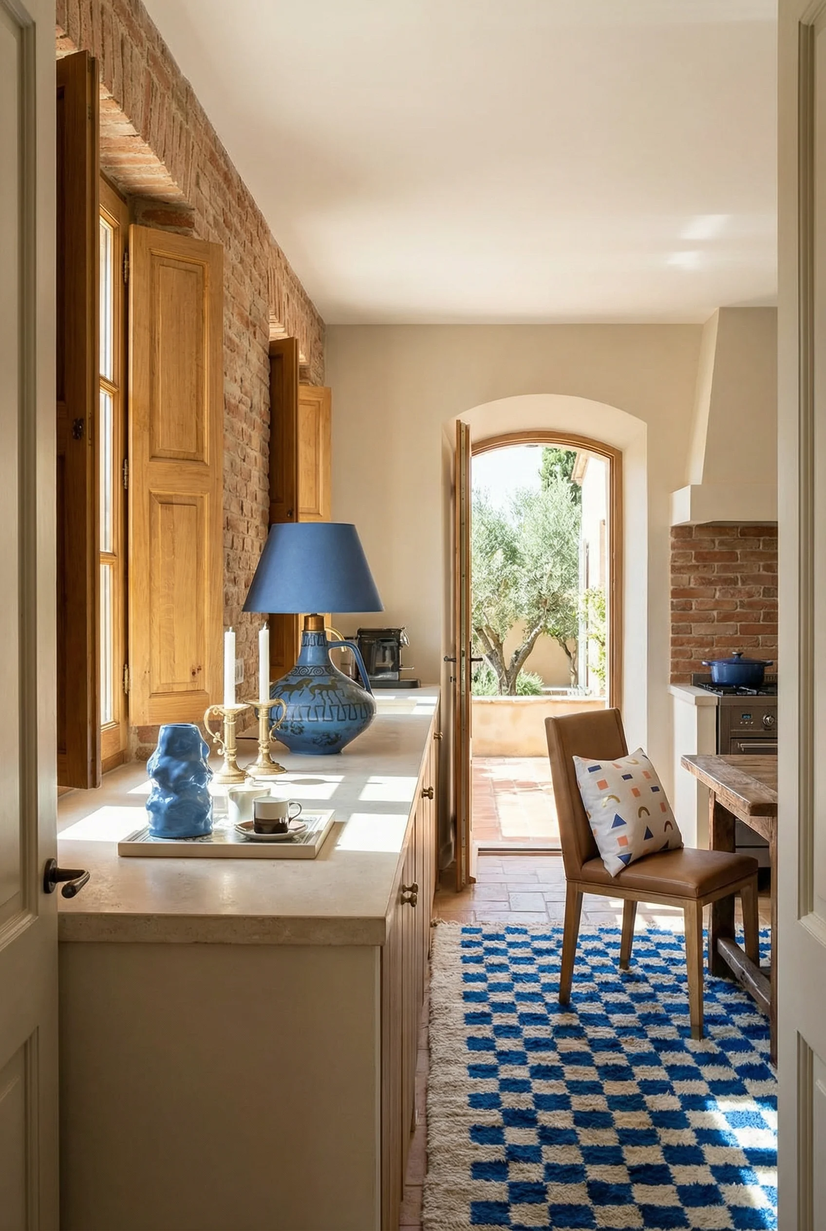 French country kitchen featuring brown oak Kalla dining chairs with terracotta backsplash and blue Ceramano lamp