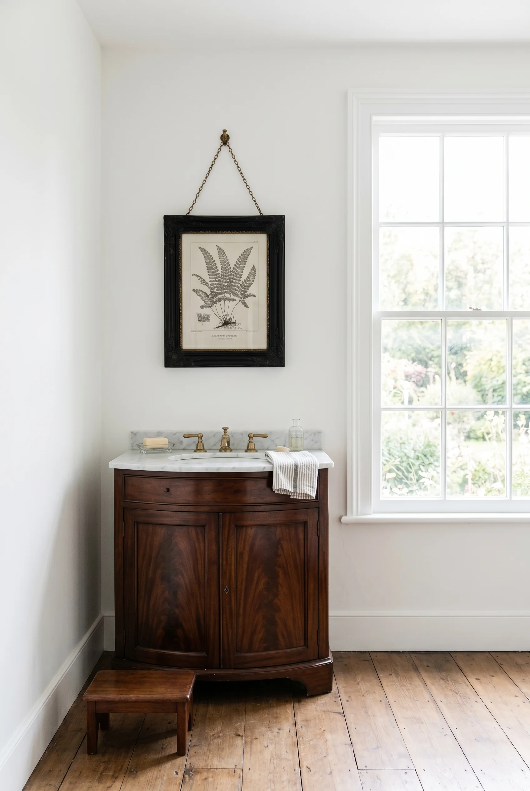 Victorian Bathroom featuring antique washstand against School House White throughout, plain walls with a single botanical print in a heavy black frame