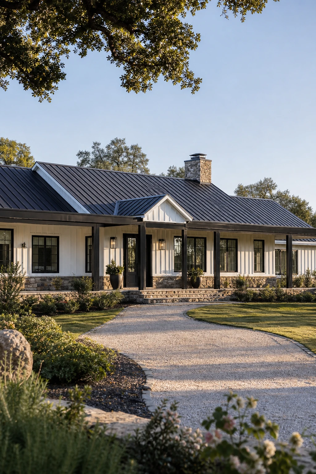 Black and white modern ranch exterior with board and batten siding, matte black windows and front door, metal roof, and stone base in bright natural light