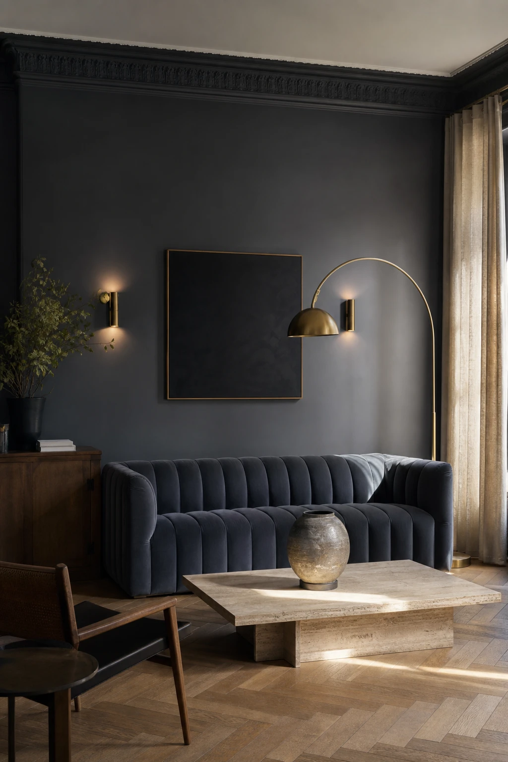 Dark blue and gray living room with charcoal blue walls in Farrow and Ball Manor House Gray, deep sofa, brass sconces, linen curtains and herringbone oak floor