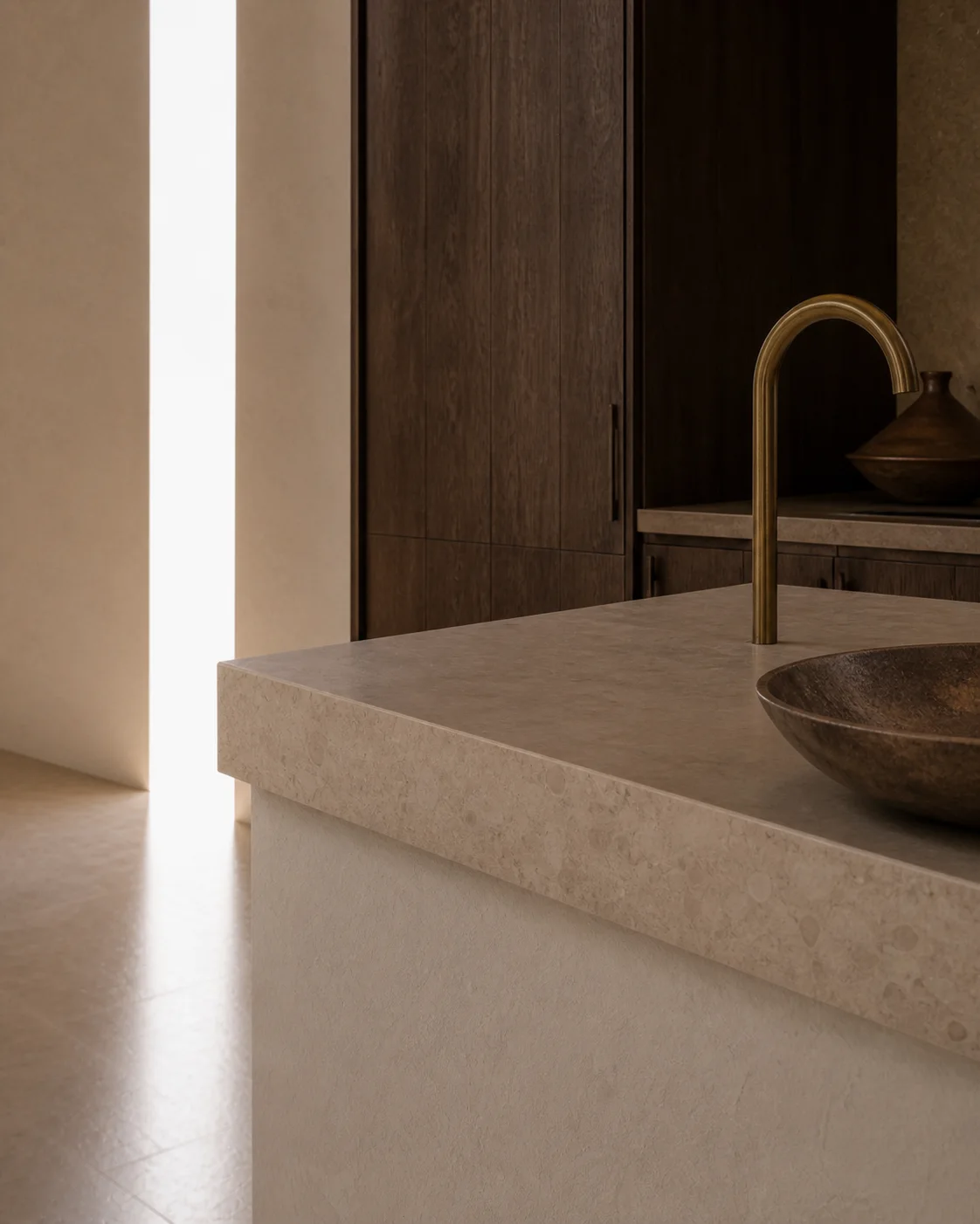 Close kitchen detail of honed limestone aged brass smoked oak and lime plaster in the quiet material palette of the Milos house part of an editorial architecture walkthrough of a..