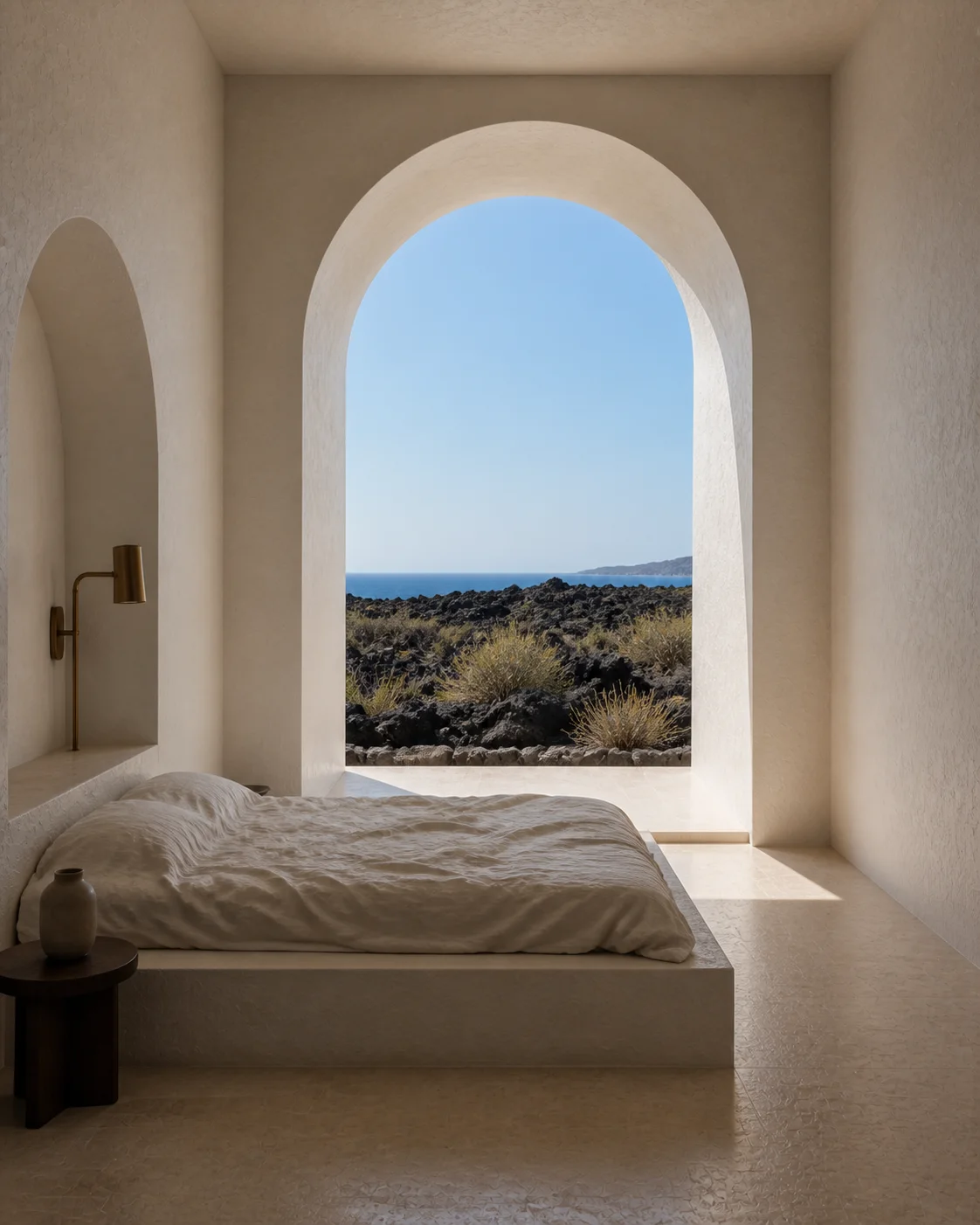 Main bedroom in the Milos house with low bed layered linen lime plaster headboard warm stone floor and framed view to the island landscape part of an editorial architecture view...