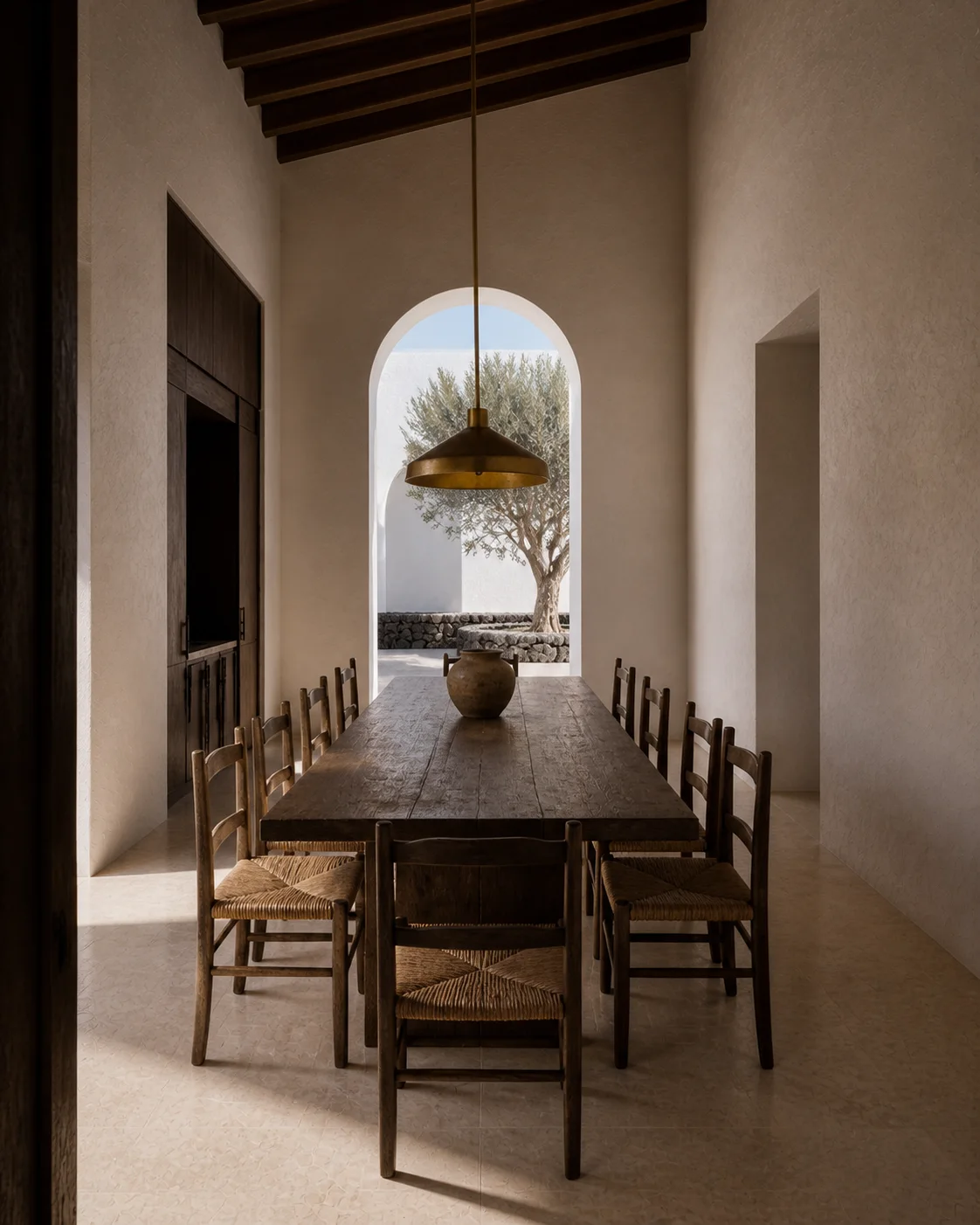 Warm Milos dining room with timber table sculptural pendant lime plaster arch handmade terracotta woven texture and soft southern daylight part of an editorial architecture view...