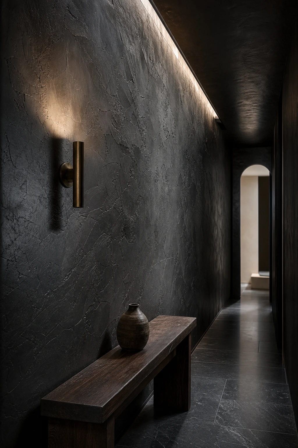 Black Mirror Black Hallway with Venetian plaster depth on walls, brass sconces, stone floor, and arched doorway in dramatic editorial light