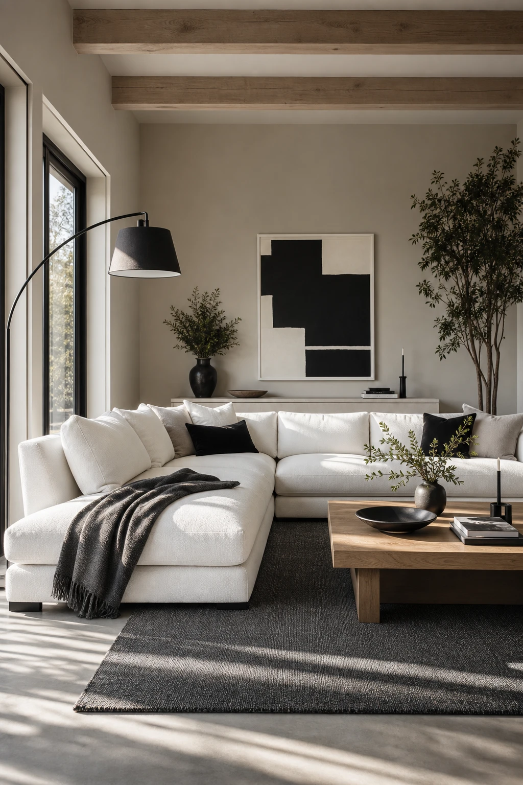 Black white gray natural wood interior with a white sectional sofa as the focal point, warm Pointing painted walls, and natural wood accents in soft afternoon light