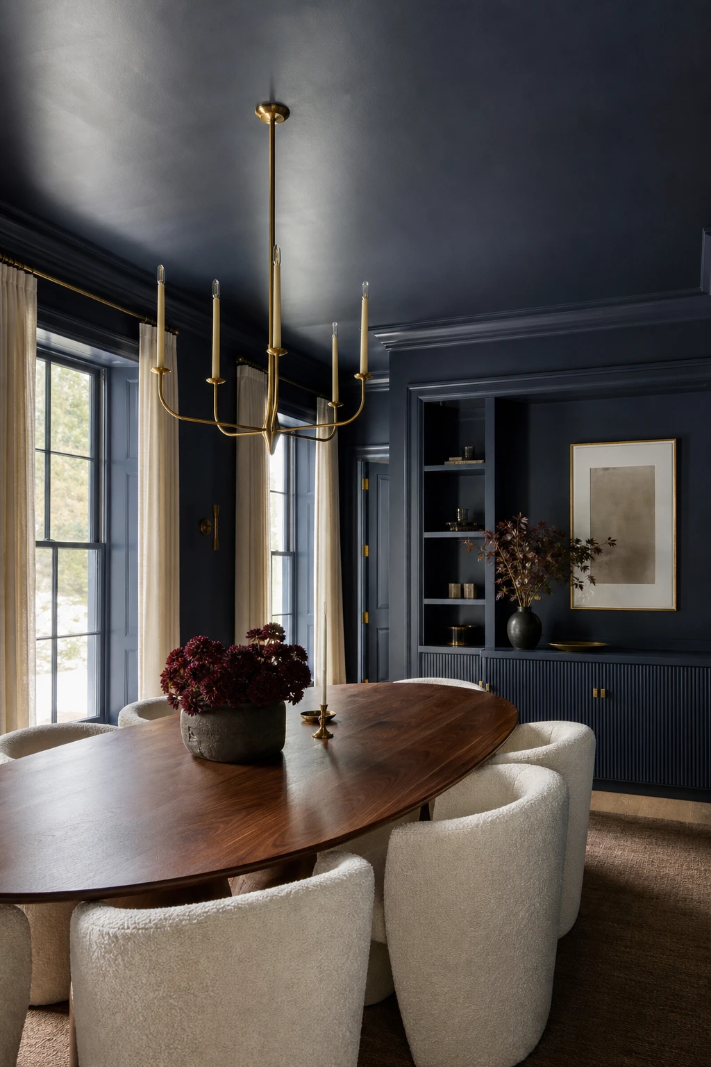 Navy blue dining room with color drenching across walls, ceiling, trim, and joinery in Farrow & Ball Belvedere Blue, creating an immersive enveloping atmosphere