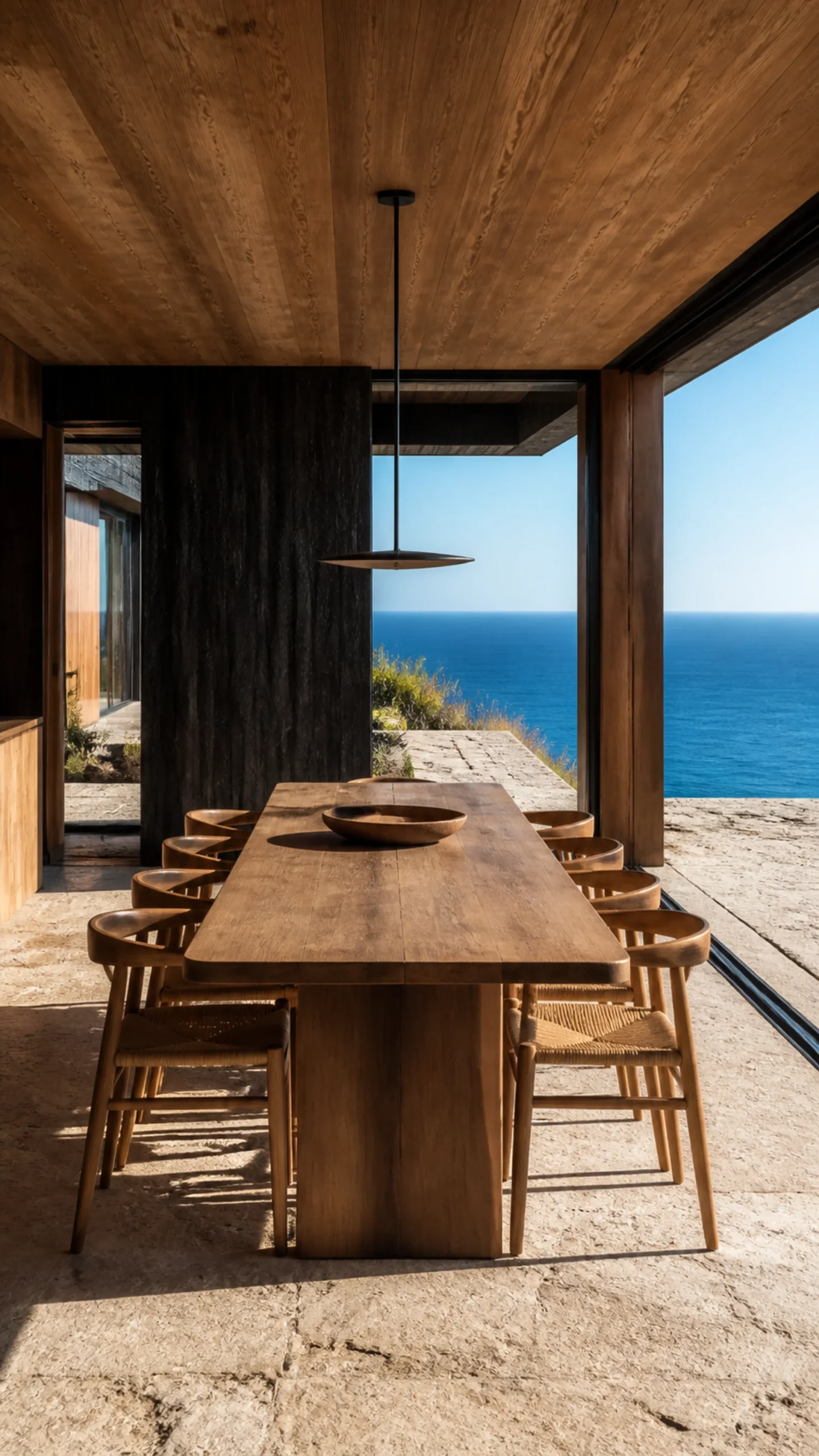 Simple timber dining room with black framed glazing facing the deep blue Aegean An original fictional editorial architecture study of material landscape light and spatial view.....