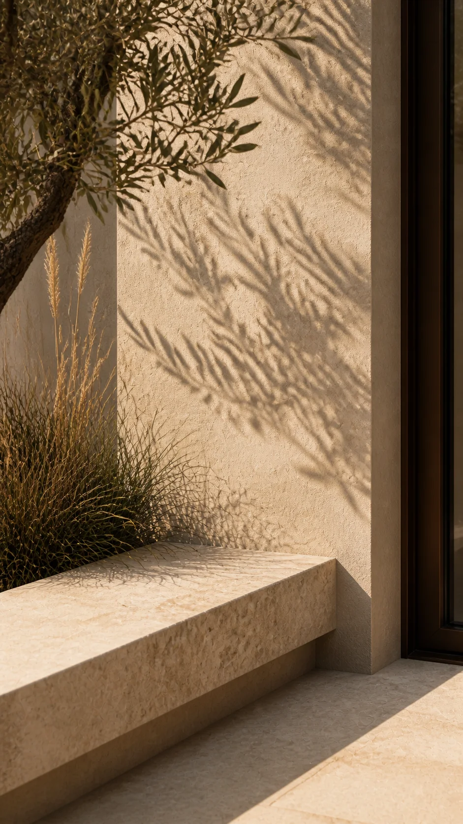 Limestone courtyard bench, warm mineral plaster, olive shadow and dry grasses at the Cala d’Hort house. This original fictional Cala d’Hort architecture study records material,....